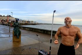 Brave-hearted Graham Robinson taking a freeing shower on Bridlington seafront to raise money for Macmillan.