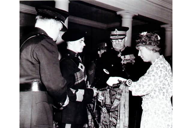 This photo was taken in 1961, when Bob was a Junior Pipe Major and presented to Royalty. 
Pictured left to right are: Lt Col LHM Gregory, Bob Etherton with his pipes, Major General L de M Thullier and the then Princess Royal. (Princess Mary – the aunt of Queen Elizabeth II).