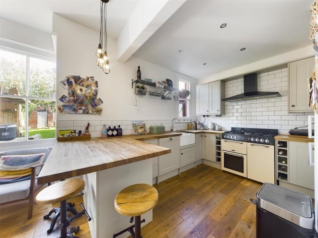 The kitchen with diner has a full range of units and solid work tops.