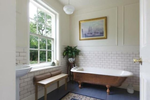 A bathroom featuring a free-standing bathtub.