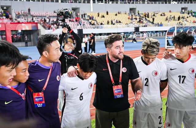 Darren Arnott gives a team talk to his Hong Kong Under-20s team during their win against China in front of 30,000 fans.