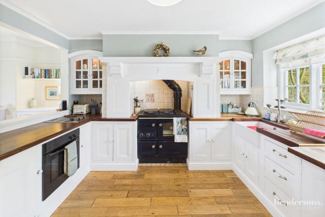 The open plan kitchen with diner has bespoke cabinetry, and a large traditional pantry.