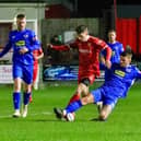 Newton Aycliffe slides in to nick the ball away from Brid Town.
