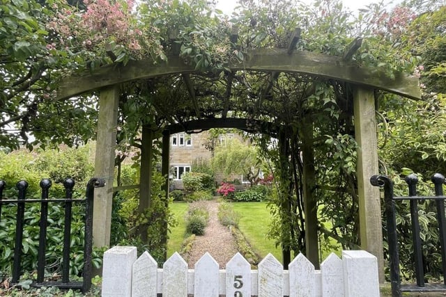 A flower-festooned garden gate welcomes you to the North Street home.