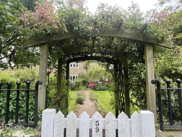 A flower-festooned garden gate welcomes you to the North Street home.