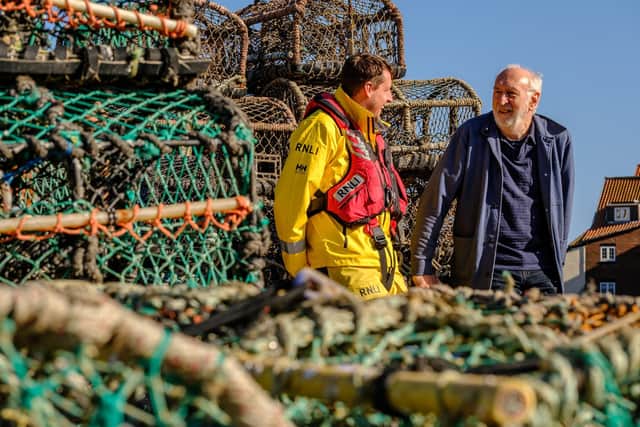 Whitby RNLI’s Senior Station Technician with Antony Bellekom, producer of Facing the Waves. Photo: Ceri Oakes/RNLI.