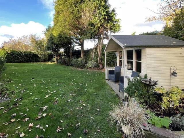 The lawned garden with summer house.