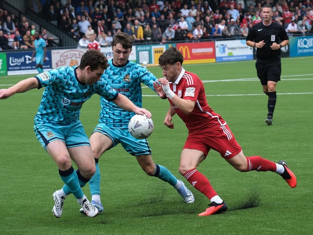 Boro left-back Alex Brown takes on two Southport defenders. Photo by Richard Ponter