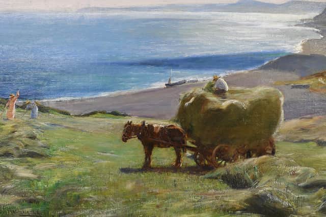 Loaded Hay Wagon and Haymaking Before a Sun Drenched Coast by Arthur A Friedenson – estimate: £1,000-1,500.