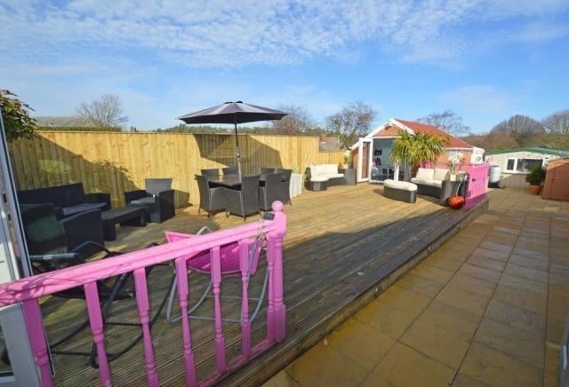 This rear decked area with spa pool enclosure is a large space ideal for entertaining.