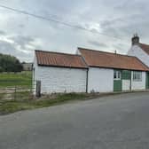 The whitewashed exterior of the cottage with annexe for sale in Folkton.
