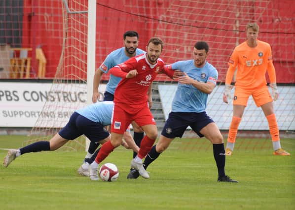 Bridlington Town striker Lewis Dennison tries to force his way through the Worksop Town defence in Saturday's clash at Queensgate. PHOTOS BY DOM TAYLOR