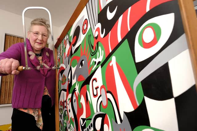 Artist Christine Cox with the distinctive panel called Town Crier