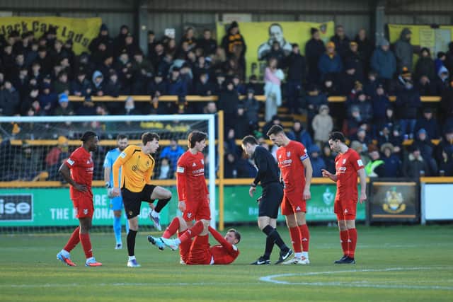 Play is stopped as Boro striker Richie Bennett goes to ground. Photo by Disport Photography