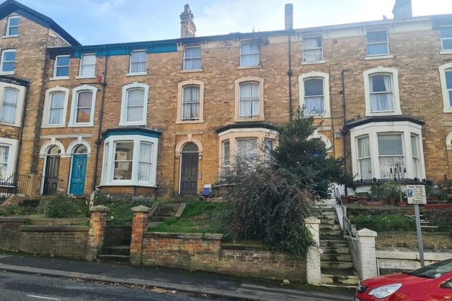 This mid-terraced house arranged as seven flats is for sale with Auction House with a starting price of £120,000.
