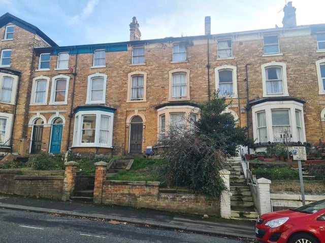 This mid-terraced house arranged as seven flats is for sale with Auction House with a starting price of £120,000.