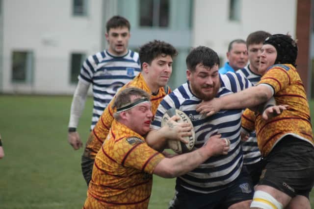 Three Harrogate defenders cannot stop Matty Downes on his way to score. Photo by Phil Gilbank