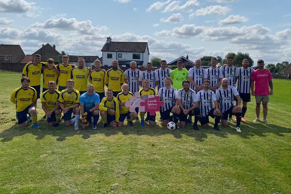 Harlee Breckon is pictured with footballers at the recent family fun day organised by William Hare Group in aid of Candlelighters.