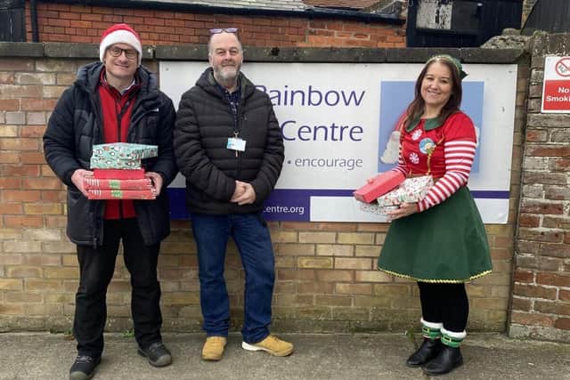 Ricky Nock, left, and Veronica Wilson, right, photographed donating presents to the Rainbow Centre.