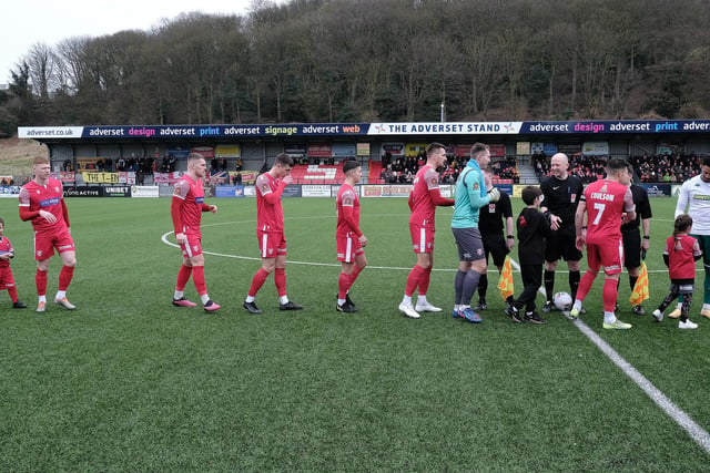 The players, mascots and officials shake hands before kick-off