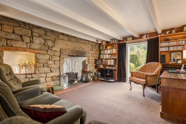 The sitting room, with stone wall and fireplace.