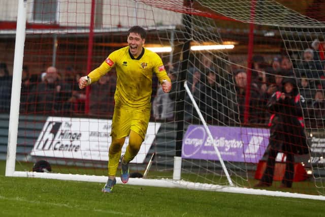 Alex Baird celebrates saving a Curzon Ashton penalty. Pic: Ewan Cameron