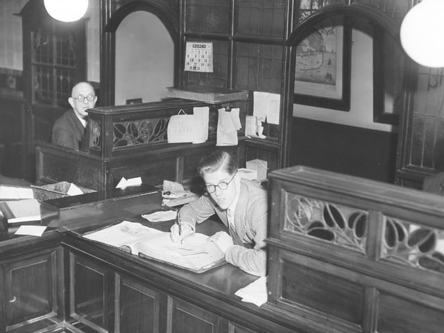 March 1949 in the Scarborough Evening News offices. Pictured is Dennis Raper in the middle, Harry Leadbetter on the left and 'Footy' sneaking in on the right.