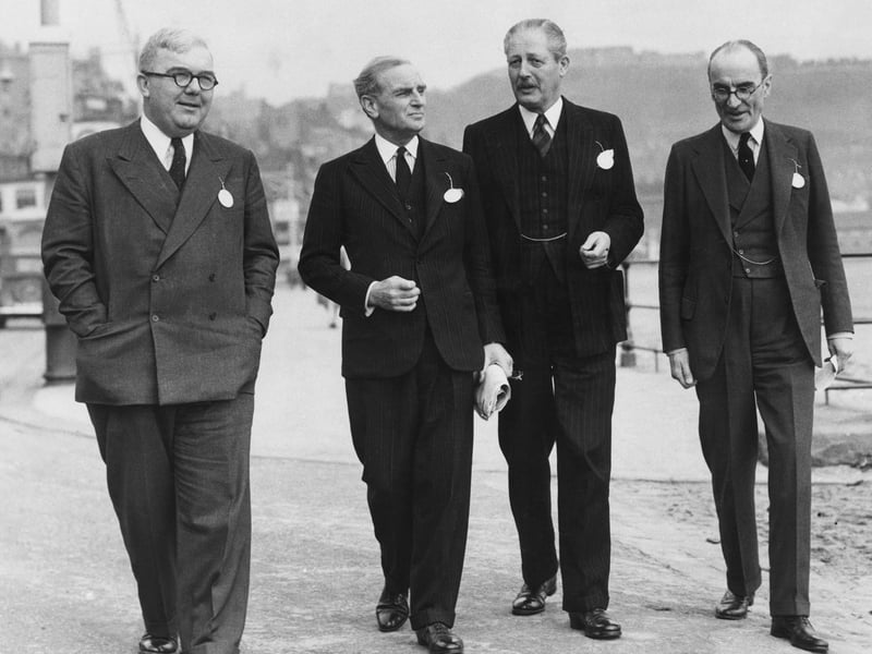 From left to right, British politician Charles Hill (1904 - 1989), Kenneth Pickthorn (1892 - 1975), Parliamentary Secretary to the Minister of Education, Harold Macmillan (1894 - 1986), the Minister of Housing, and Sir Geoffrey Hutchinson, 12th October 1952.