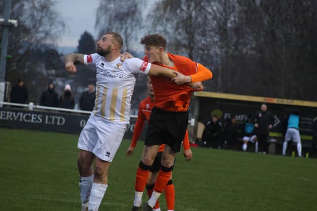 Brid Town striker Jake Day holds off a Brighouse player. Photo by Ewan Cameron