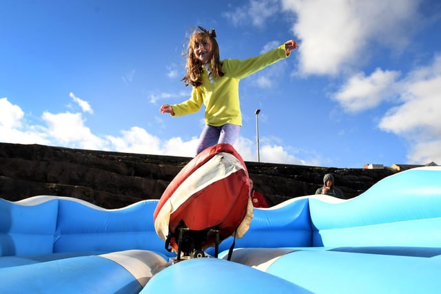 Tabitha Smith, 6, from Scarborough has a go on the Surf Simulator.