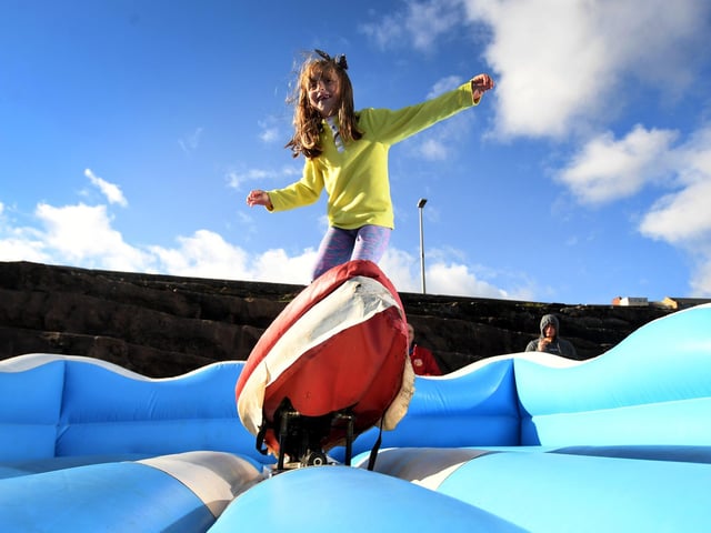Tabitha Smith, 6, from Scarborough has a go on the Surf Simulator.