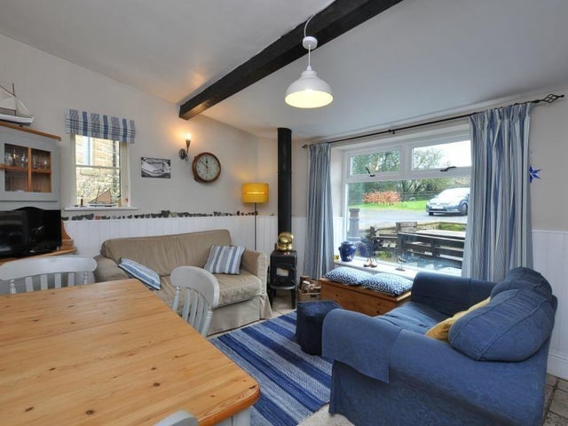 The beamed breakfast or morning room has a cosy log burner.