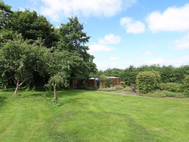 Landscaped gardens wraparound the property to provide plenty of green space, complete with hedges, flower beds and bushes.