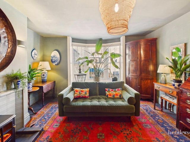 A bay-fronted reception room with feature fireplace.