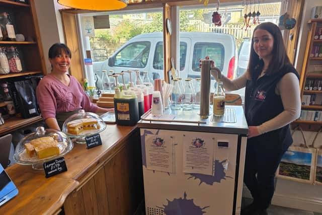 Off the Scale owner Lizzie Watson (L) was delighted to welcome Udderly Dale-icious's vending machine to her shop - pictured with Kim Johnson