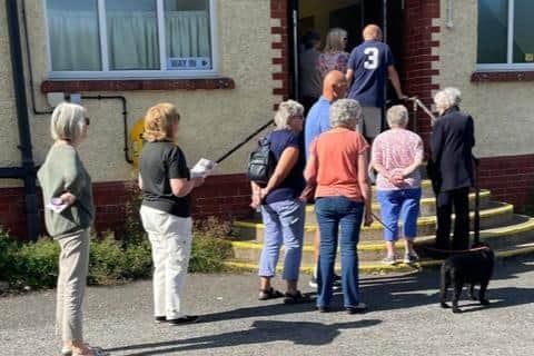 Parishioners queuing to vote in the parish poll at Newby and Scalby Community Hall, Scalby.