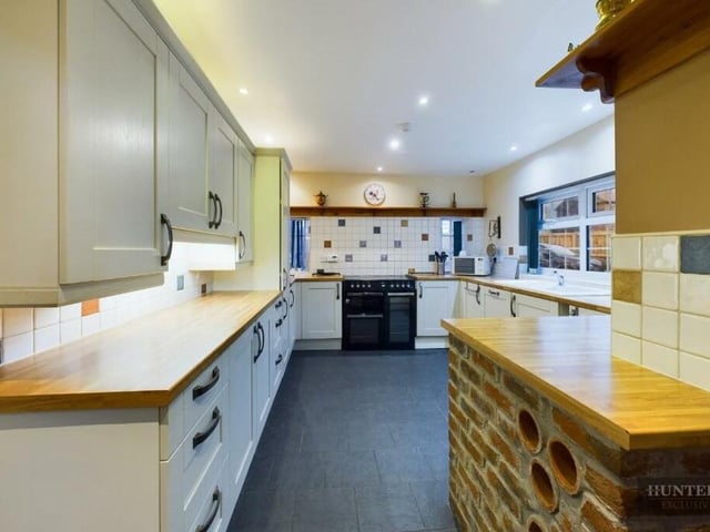 The kitchen has an extensive range of units with integrated appliances.