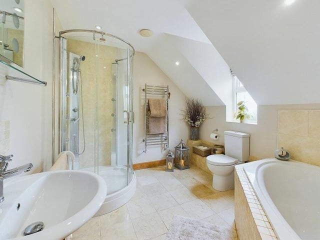 A luxurious main bathroom with both bath and separate shower unit.