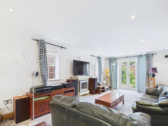 A large reception room with French doors to the garden.