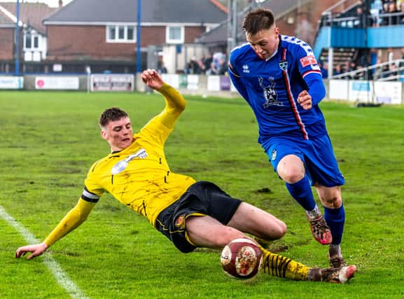 The Belper skipper tries to nick the ball away from Whitby Town's Aaron Haswell.