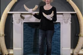 Curator of From Local to Global Dorcas Taylor with some of the exhibits