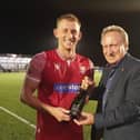 Legendary former Scarborough FC manager Neil Warnock hands over the man of the match award to Ash Jackson after Boro's 2-2 home draw with Bradford PA