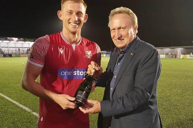 Legendary former Scarborough FC manager Neil Warnock hands over the man of the match award to Ash Jackson after Boro's 2-2 home draw with Bradford PA