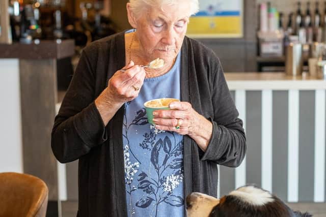 A guest and her dog enjoying an ice cream in Skirlington Coast’s Wonky Donkey pub and restaurant.