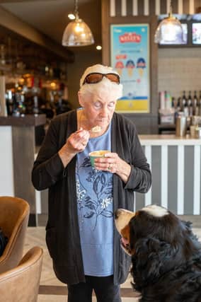 A guest and her dog enjoying an ice cream in Skirlington Coast’s Wonky Donkey pub and restaurant.