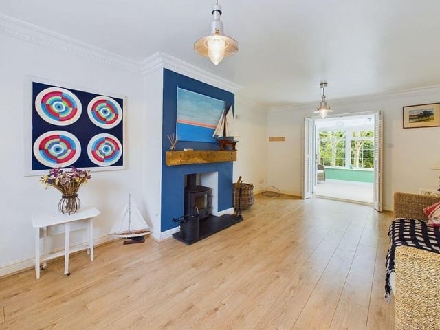 This lounge with log burner has French doors through to the garden room.