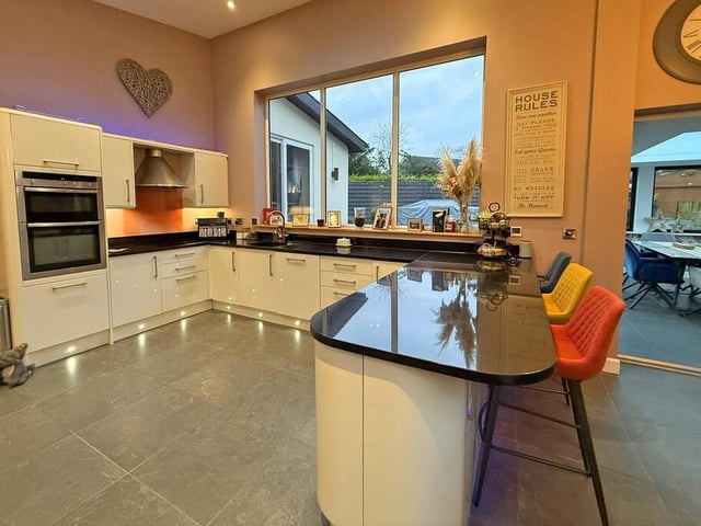 The sleek and modern living kitchen, with breakfast bar.