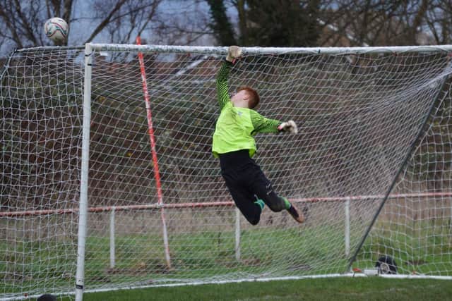 The keeper makes a superb flying save to keep out a Dragons shot