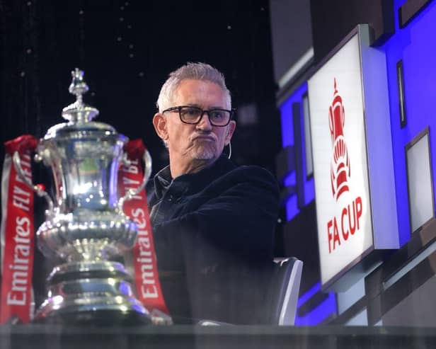 Gary Lineker sits in the BBC Studio next to the FA Cup