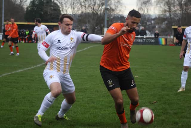 Bridlington Town skipper Matty Dixon closes in on a Brighouse player. Photo by Ewan Cameron